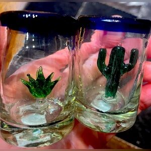 Blue rim Mexican shot glasses, made in Mexico. Cactus/agave sculptures inside.